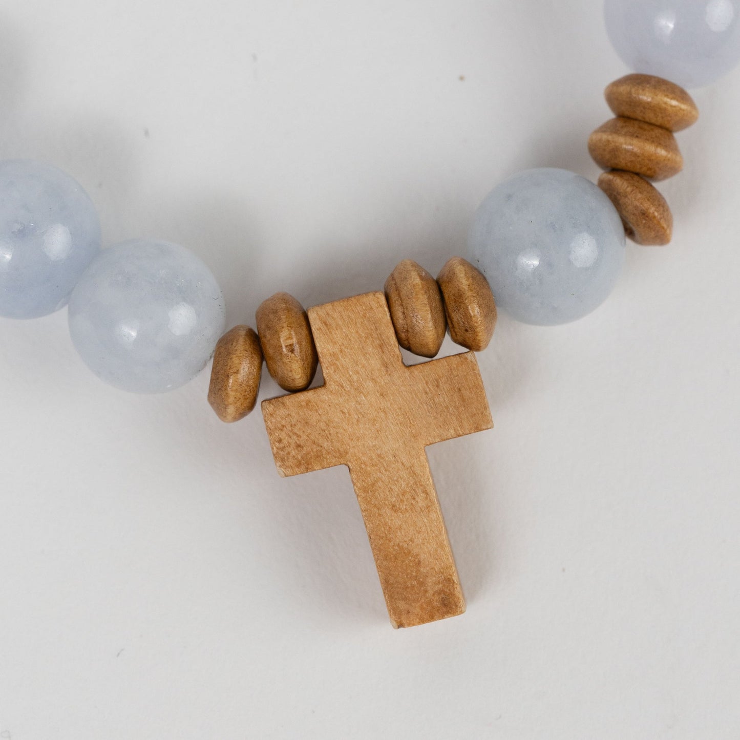 Bracelet stretch w/cross charm stn/wd lt blu/brn