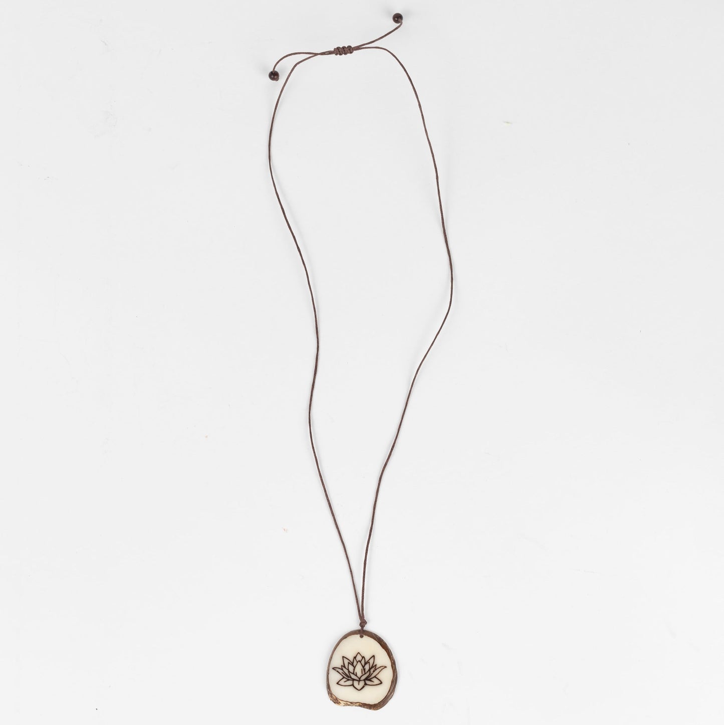 Necklace lotus pendant tagua/cord 16L nat/brn